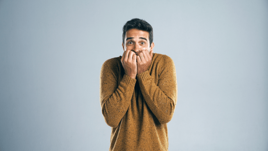 Man looking scared on gradient background