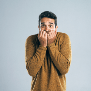 Man looking scared on gradient background