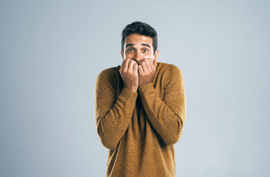 Man looking scared on gradient background